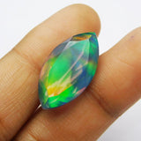 Natural Boulder Opal Marquise Cut held in hand scale photo