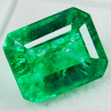 Emerald cut natural green emerald on white background