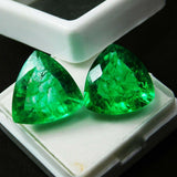 Matching trillion emerald pair in white jewel box