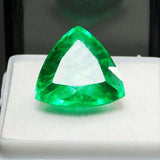 Close-up image of the 8.13 Ct certified Colombian emerald, perfectly placed in a white jewel holder for premium display against a contrasting black background.