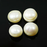 A set of four white, round Shape natural pearl gemstones against a black background.