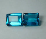 Translucent Blue Aquamarine Emerald Cut Pair displayed flat on white surface