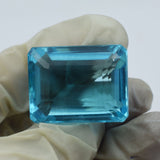 Blue Aquamarine 72.65 Ct Lab-Created Gemstone Shown in Hand with Gloves - Rectangular Emerald Shape