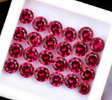 Round Red Ruby Gemstones Set of 20 Arranged on White Surface Natural and Not Enhanced