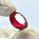 Gloved Fingers Holding 13.75 Ct Oval Blood Red Ruby Gemstone Natural Certified from Burma