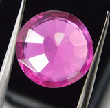 Reverse View of 9.23 Ct Round Pink Ruby Held with Jewelry Holder – Natural Gemstone Showing Backside