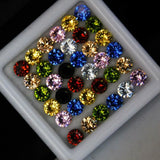 Assorted colored gemstones in a white container