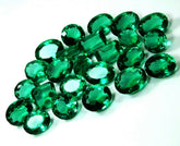 Group of 5â8 lab-created emerald gemstones on white background