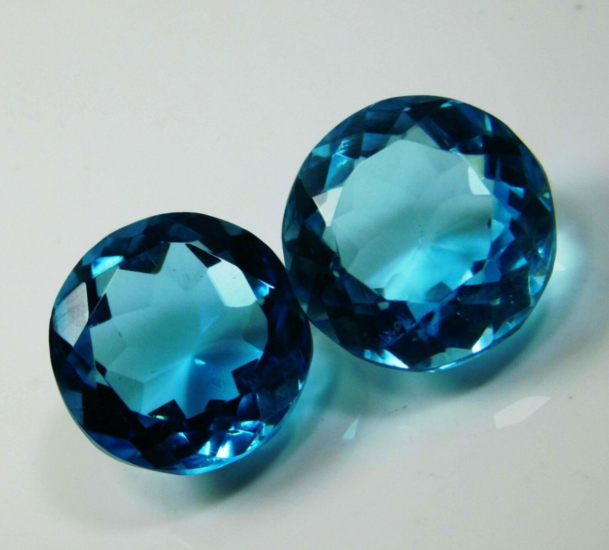 16.58 Ct Ocean Blue Aquamarine Round Cut Gemstone Pair on White Background - Certified and Eye Clean