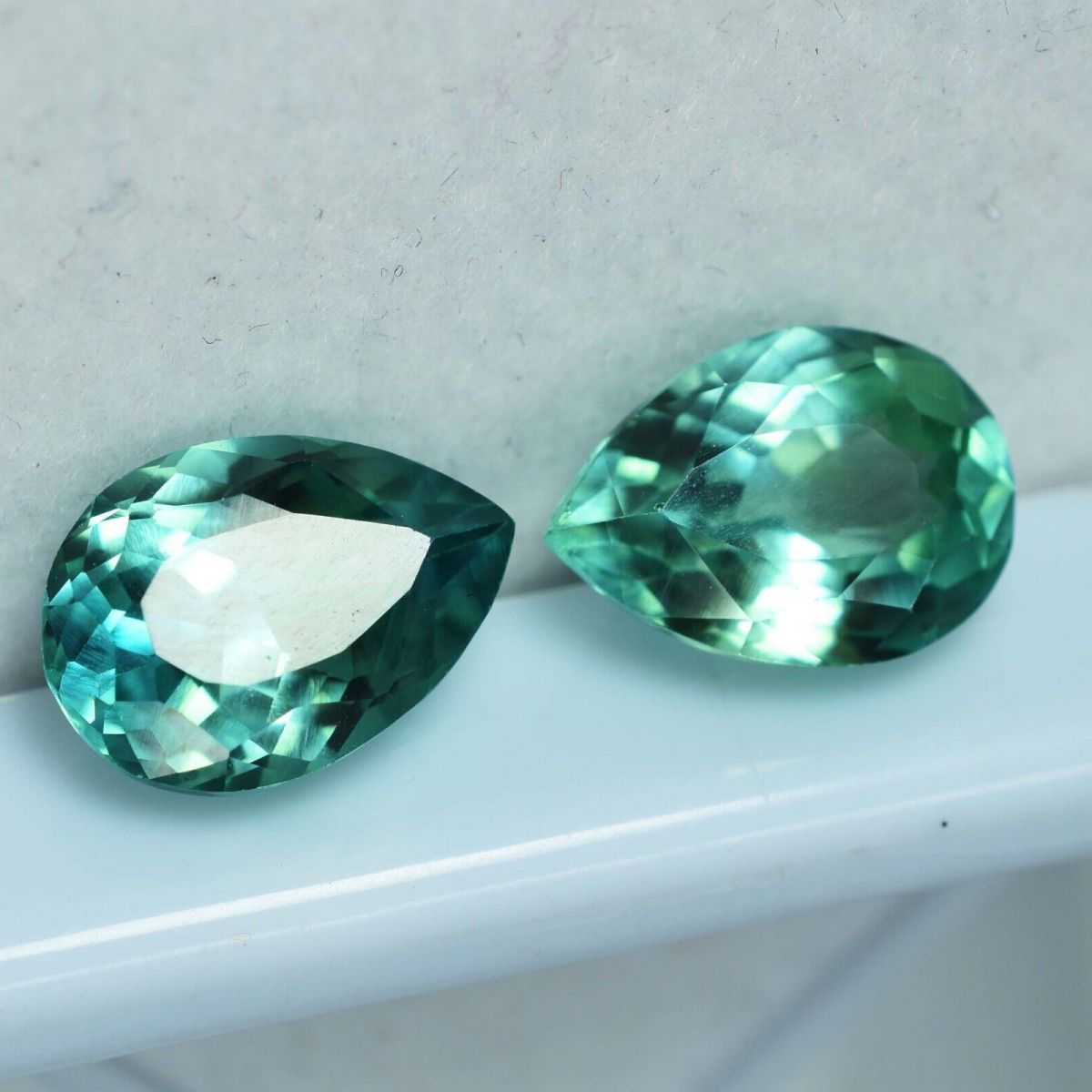 Certified 17 ct natural grandidierite pair, bluish-green pear cut loose gemstones.