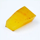 Yellow cheese wedge on a white background