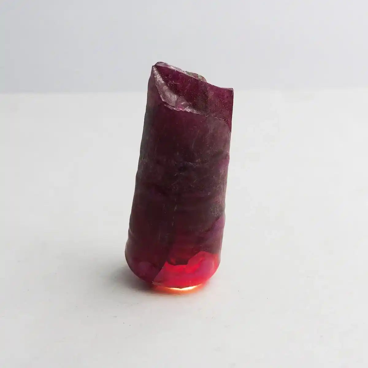 Polished red crystal on a white background