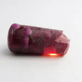 Polished purple gemstone on a white background