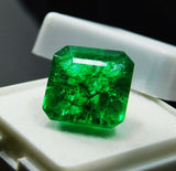 A 7 Ct eye-clean green Colombian emerald showcased in a white jewelry box, capturing its clarity-enhanced brilliance and translucent finish.