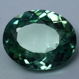Loose certified Montana sapphire, 11.25 ct bluish-green oval cut natural gemstone.