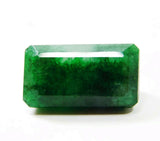 horizontal view of the 24.65 Ct certified Colombian emerald with vivid green tone, highlighting its natural untreated clarity and symmetrical emerald cut.