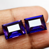 18.54 Ct Natural Purple Tanzanite Emerald Cut Gemstone Displayed Between Fingers