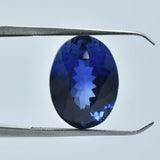 12.85 Carat Oval Cut Blue Tanzanite Held by Gem Tool
