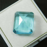 Emerald Shape Aquamarine 10 Ct Lab Created Gemstone Placed on White Box Loupe Clean Clarity