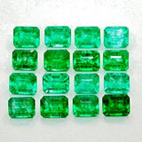 Emerald lot displayed in clear rectangular grid pattern on light surface