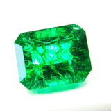 Loose emerald gemstone placed in angled position displaying its emerald cut