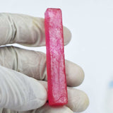 Red Ruby Rough next to ruler showing length 64.7 mm approx