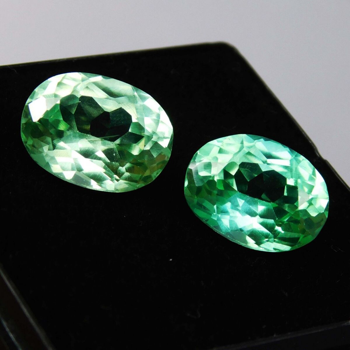 High-quality certified grandidierite pair, oval shape, bluish-green, total weight 16 carats.