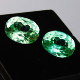High-quality certified grandidierite pair, oval shape, bluish-green, total weight 16 carats.