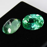 High-quality certified grandidierite pair, oval shape, bluish-green, total weight 16 carats.