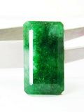 Vertically displayed 24.65 Ct natural Colombian green emerald, revealing its flawless emerald cut, deep green color, and excellent transparency on a clean white background.
