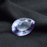 Loose 10.55 Ct Alexandrite displayed on black background emphasizing deep tones and cut