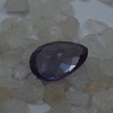 Color-change Alexandrite placed again among white rough stones highlighting natural elegance