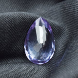 Vertical view of pear cut Alexandrite on black background showing full shape and symmetry