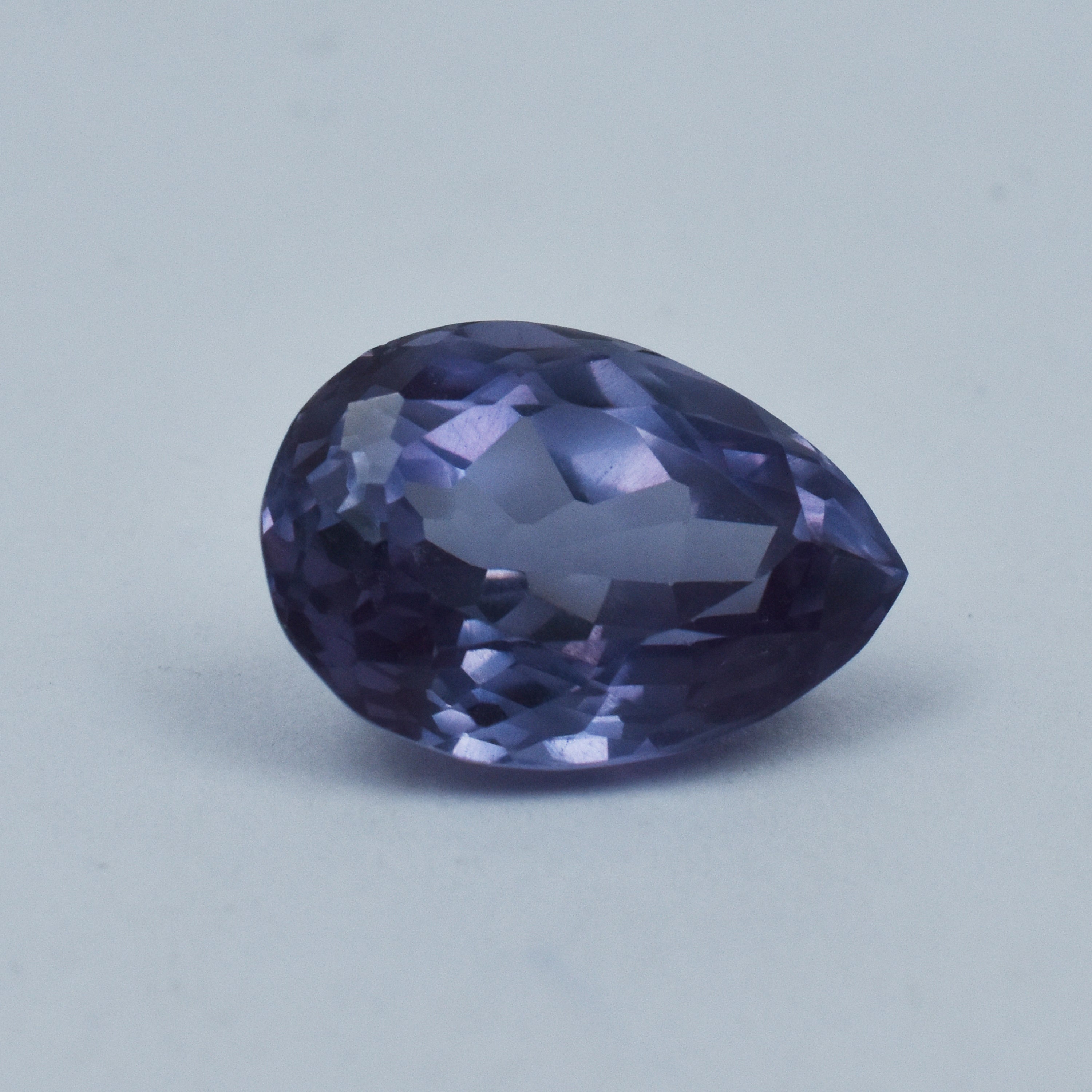 Certified 10.55 Ct Alexandrite pear cut gemstone displayed on white background for jewelry design