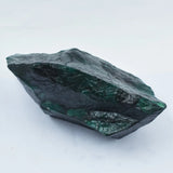 Raw emerald stone on a white background