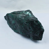 Greenish-brown mineral rock on a white background
