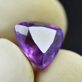 Certified Purple Tanzanite Trillion Cut Gemstone 7.45 Carat Held by Fingers