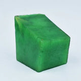 Green cube-shaped object on a light blue background