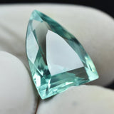Bluish Green Montana Sapphire next to ruler showing size 13.5mm