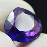 Natural Pear Cut Purple Tanzanite 6.85 Ct Gemstone Held in Hand – Certified & Clarity Enhanced