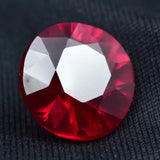 Red gemstone on a dark textured background