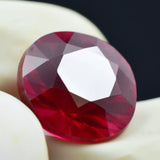 Faceted red gemstone on a white background