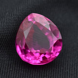 12.95 Ct pink ruby gemstone displayed on plain black background highlighting brilliance
