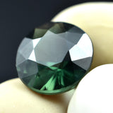 Deep green sapphire, 5.40ct, a round-shaped natural certified gemstone.