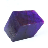 500 carat rough natural Tanzanite gemstone, uncut purple crystal shown on white background.