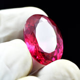 A stunning 26.25-carat natural bi-color oval-cut sapphire, displaying a beautiful transition of colors.