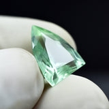 natural Montana sapphire, 6.45 carats, with a fancy cut and bluish-green color, certified.