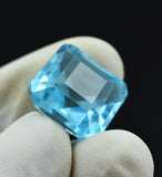 Blue Aquamarine Square Cut 13.65 Ct Gemstone Held Between Fingers