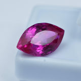6.90 Ct pink ruby loose gemstone resting on white box, eye-clean clarity visible