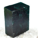 “Natural dark green gemstone slab surrounded by amethyst-colored raw crystals.”